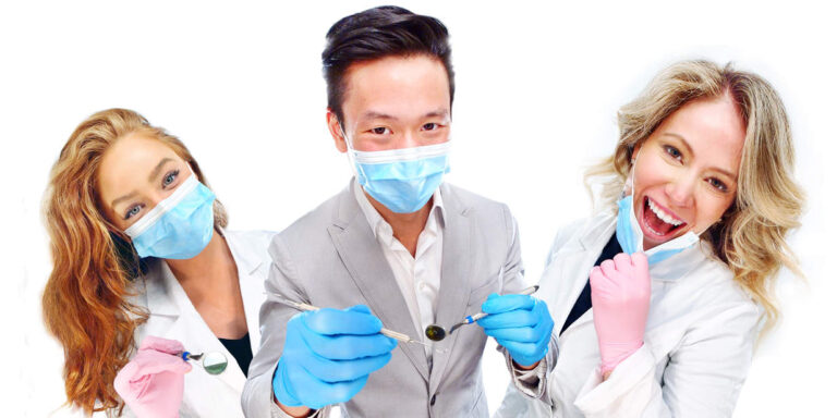 3 Smiling dental professionals with masks.